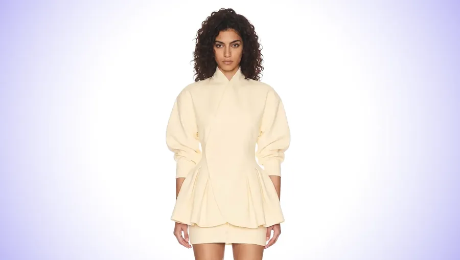 A cream tailored jacket worn by a generated model against a studio backdrop